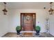 Ornate wood front door with welcoming decor at 8219 N 3Rd Ave, Phoenix, AZ 85021