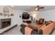 Cozy living room boasts a fireplace, comfortable seating, and large TV at 8219 N 3Rd Ave, Phoenix, AZ 85021