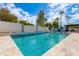 Inviting rectangular pool with light-grey tile deck and lounge chairs at 8219 N 3Rd Ave, Phoenix, AZ 85021