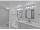 Updated bathroom with double vanity, marble tile, and a walk-in shower at 1051 S Dobson Rd # 165, Mesa, AZ 85202