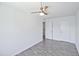 Bright bedroom with gray flooring, ceiling fan, and double door closet at 1051 S Dobson Rd # 165, Mesa, AZ 85202