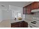 Bright kitchen features a breakfast bar with granite countertops and white tile backsplash at 1051 S Dobson Rd # 165, Mesa, AZ 85202