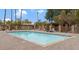 A large, well-maintained outdoor swimming pool area with lounge chairs, tables and a fence at 1051 S Dobson Rd # 165, Mesa, AZ 85202