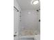 Large walk-in shower with marble tile and built-in shelving at 1051 S Dobson Rd # 165, Mesa, AZ 85202