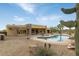 Desert landscaping surrounds a sparkling pool and patio area at 10630 E Cactus View Cir, Gold Canyon, AZ 85118