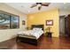 Bedroom with wood floors, yellow accent wall and ensuite bathroom at 10630 E Cactus View Cir, Gold Canyon, AZ 85118