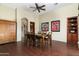 Formal dining room with hardwood floors, wood furniture, and artwork at 10630 E Cactus View Cir, Gold Canyon, AZ 85118