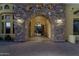 Elegant entryway with a stone arch and glass double doors at 10630 E Cactus View Cir, Gold Canyon, AZ 85118