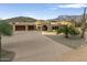 Stunning home exterior with mountain backdrop and palm trees at 10630 E Cactus View Cir, Gold Canyon, AZ 85118