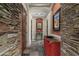 Stone hallway with red walls and a red cabinet at 10630 E Cactus View Cir, Gold Canyon, AZ 85118