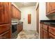 Well-appointed laundry room with wood cabinets and granite countertops at 10630 E Cactus View Cir, Gold Canyon, AZ 85118