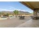 Large patio with seating area, adjacent to the pool and outdoor kitchen at 10630 E Cactus View Cir, Gold Canyon, AZ 85118