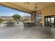 Outdoor patio with pool, built-in grill, and seating area at 10630 E Cactus View Cir, Gold Canyon, AZ 85118