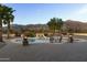 Inviting pool area with mountain views, fire pits, and patio seating at 10630 E Cactus View Cir, Gold Canyon, AZ 85118