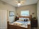 Spacious bedroom with wood framed bed and ceiling fan at 10660 W Monaco Blvd, Arizona City, AZ 85123