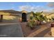 House exterior featuring a two-car garage and palm trees at 10660 W Monaco Blvd, Arizona City, AZ 85123