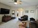 Living room with seating, a large TV and view to the backyard at 10660 W Monaco Blvd, Arizona City, AZ 85123