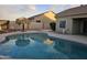 Backyard pool with a thatched umbrella at 10660 W Monaco Blvd, Arizona City, AZ 85123