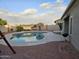 Relaxing backyard oasis with a kidney-shaped pool and grill at 10660 W Monaco Blvd, Arizona City, AZ 85123