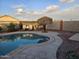 Kidney shaped pool with patio and lounge chairs at 10660 W Monaco Blvd, Arizona City, AZ 85123