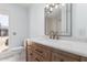 Modern bathroom with wood vanity and gold fixtures at 10826 W Loma Blanca Dr, Sun City, AZ 85351