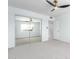 Bedroom with mirrored closet doors and ceiling fan at 10826 W Loma Blanca Dr, Sun City, AZ 85351