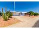 Front view of a single story home with a gravel driveway and cactus landscaping at 10826 W Loma Blanca Dr, Sun City, AZ 85351