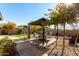 Backyard patio with gazebo, seating area, and lush landscaping at 11047 E Tupelo Ave, Mesa, AZ 85212