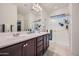 Modern bathroom with dual sinks, a large shower and ample storage at 11047 E Tupelo Ave, Mesa, AZ 85212