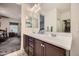 Clean bathroom with dual sinks and a view into the bedroom at 11047 E Tupelo Ave, Mesa, AZ 85212