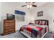 Cozy bedroom featuring a comfortable bed, dresser, and ceiling fan at 11047 E Tupelo Ave, Mesa, AZ 85212