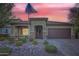 One-story home with a brown garage door and landscaped front yard at 11047 E Tupelo Ave, Mesa, AZ 85212