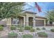 Landscaped front yard with a one-story home and American flag at 11047 E Tupelo Ave, Mesa, AZ 85212