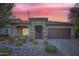 Single-story home with attractive landscaping and a two-car garage at 11047 E Tupelo Ave, Mesa, AZ 85212