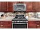 Modern gas range and microwave in kitchen at 11047 E Tupelo Ave, Mesa, AZ 85212