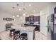 Granite kitchen island with seating for three and stainless steel appliances at 11047 E Tupelo Ave, Mesa, AZ 85212