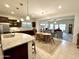 Open-concept kitchen and dining area with dark wood cabinets and granite countertops at 11047 E Tupelo Ave, Mesa, AZ 85212