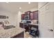 Kitchen with pull-out shelving and granite countertops at 11047 E Tupelo Ave, Mesa, AZ 85212