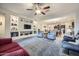 Spacious living room featuring built-in shelving and a view into the kitchen at 11047 E Tupelo Ave, Mesa, AZ 85212