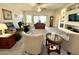 Spacious living room with neutral carpet, ceiling fan, and plenty of natural light at 11047 E Tupelo Ave, Mesa, AZ 85212