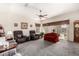 Comfortable living room with gray carpet, two recliners, and a red couch at 11047 E Tupelo Ave, Mesa, AZ 85212