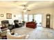 Inviting living room with neutral carpet, ceiling fan, and large windows at 11047 E Tupelo Ave, Mesa, AZ 85212