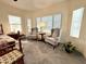 Comfortable main bedroom with an additional seating area, lots of light, and neutral-colored walls at 11047 E Tupelo Ave, Mesa, AZ 85212