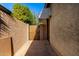 Side yard access with a gate and brick pathway at 11047 E Tupelo Ave, Mesa, AZ 85212