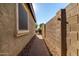 Side yard with a brick pathway and block wall at 11047 E Tupelo Ave, Mesa, AZ 85212