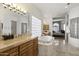 Elegant bathroom with soaking tub, double sinks, and glass block accents at 12067 N 135Th Way, Scottsdale, AZ 85259