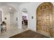 Bright and spacious entryway with arched doorways and elegant flooring at 12067 N 135Th Way, Scottsdale, AZ 85259