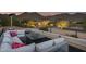 Relaxing rooftop terrace with sectional seating, fire pit, and mountain views at 12067 N 135Th Way, Scottsdale, AZ 85259