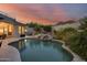 Luxury pool with a spa, waterfall and mountain views at sunset at 12067 N 135Th Way, Scottsdale, AZ 85259