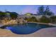 Expansive swimming pool with a waterfall and mountain views at 12067 N 135Th Way, Scottsdale, AZ 85259